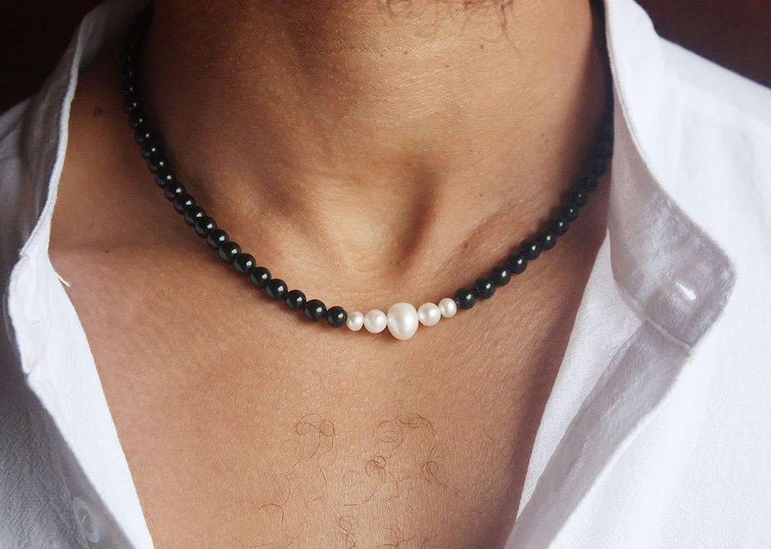 A photorealistic close‑up of a hand wearing a bright orange crystal bracelet, the beads catching sunlight, with a soft,