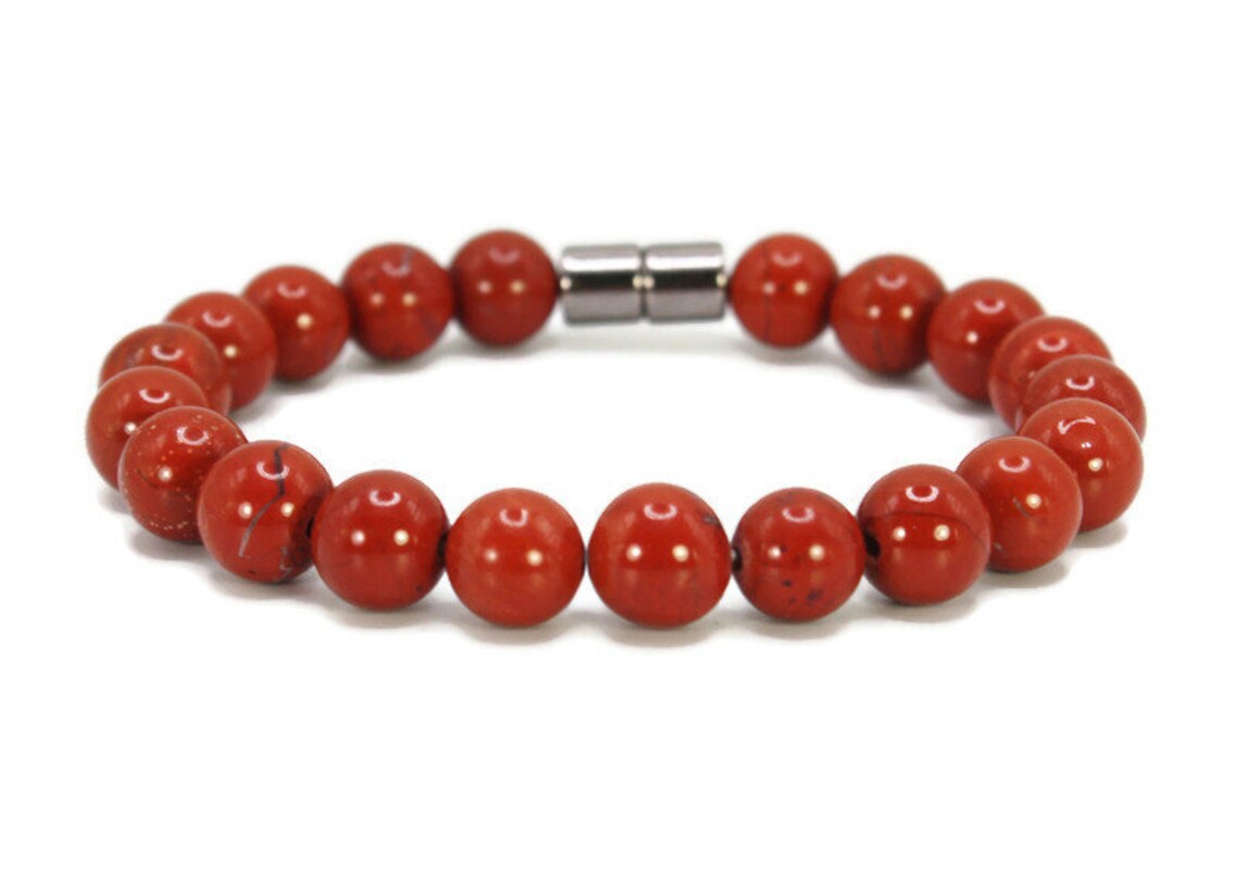 Close-up of genuine red jasper beads on a handmade bracelet
