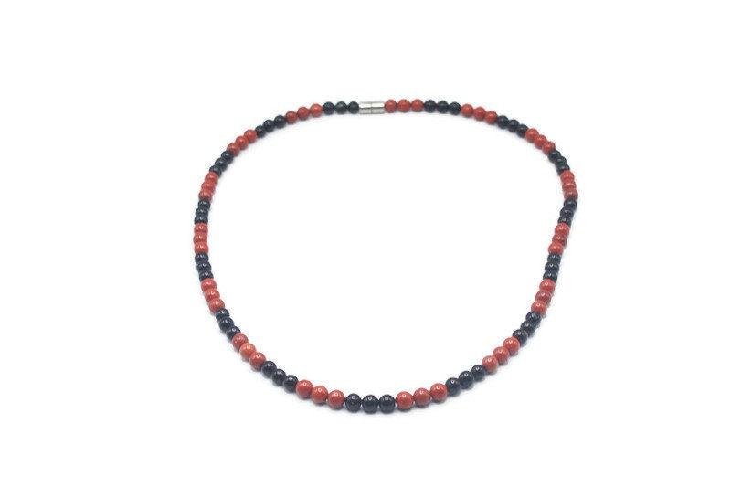 Onyx and red jasper beaded necklace displayed in clean natural light